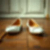 Elegant white flat shoes on a vintage wooden floor