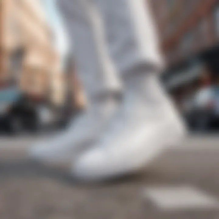 A fashionable individual sporting all white skate shoes in an urban setting, capturing street style.