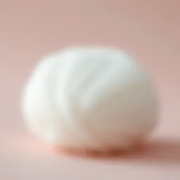 Close-up of a one-size powder puff showcasing its soft texture and unique shape